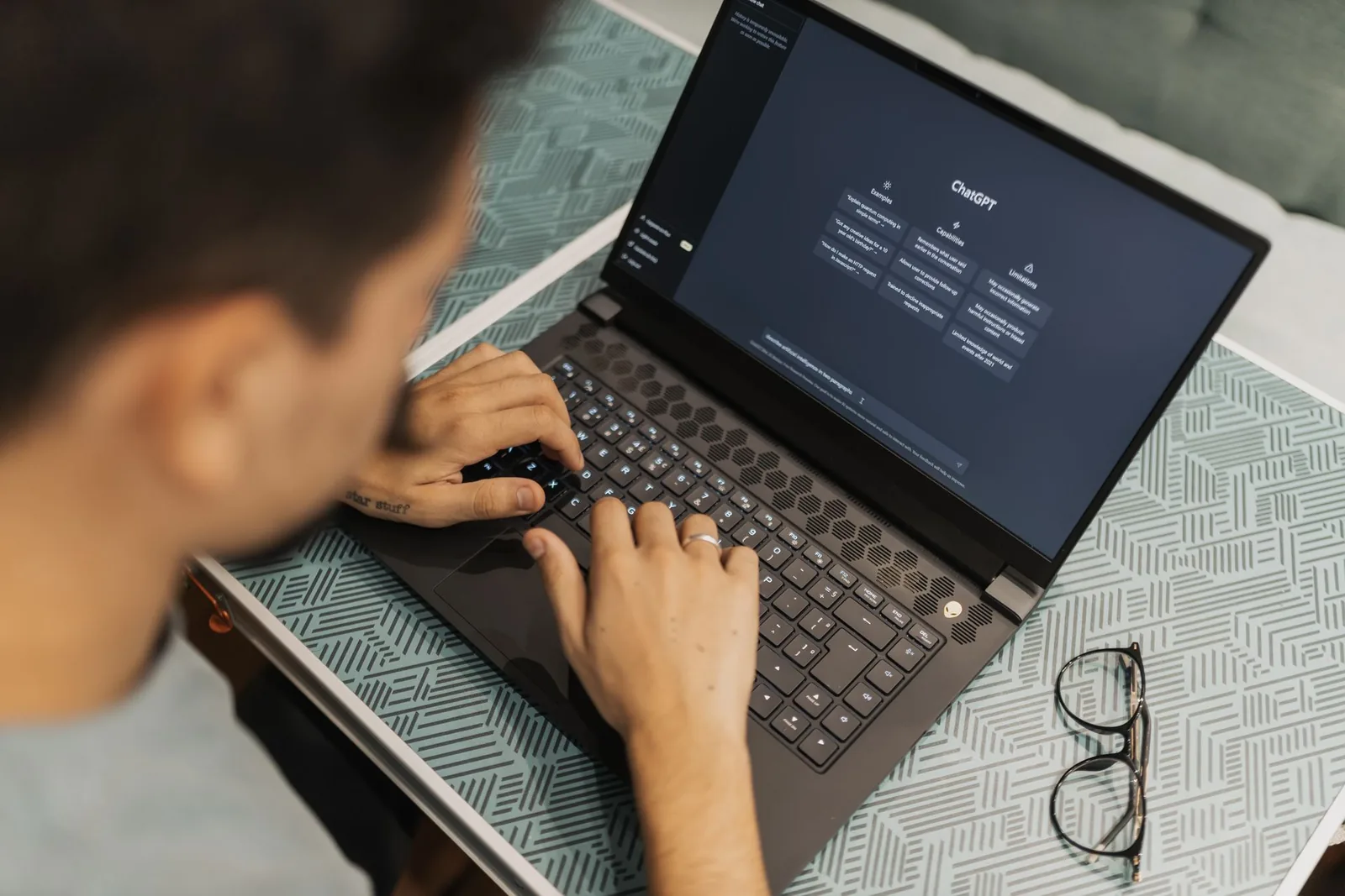 Professional using AI software on a laptop in a modern office