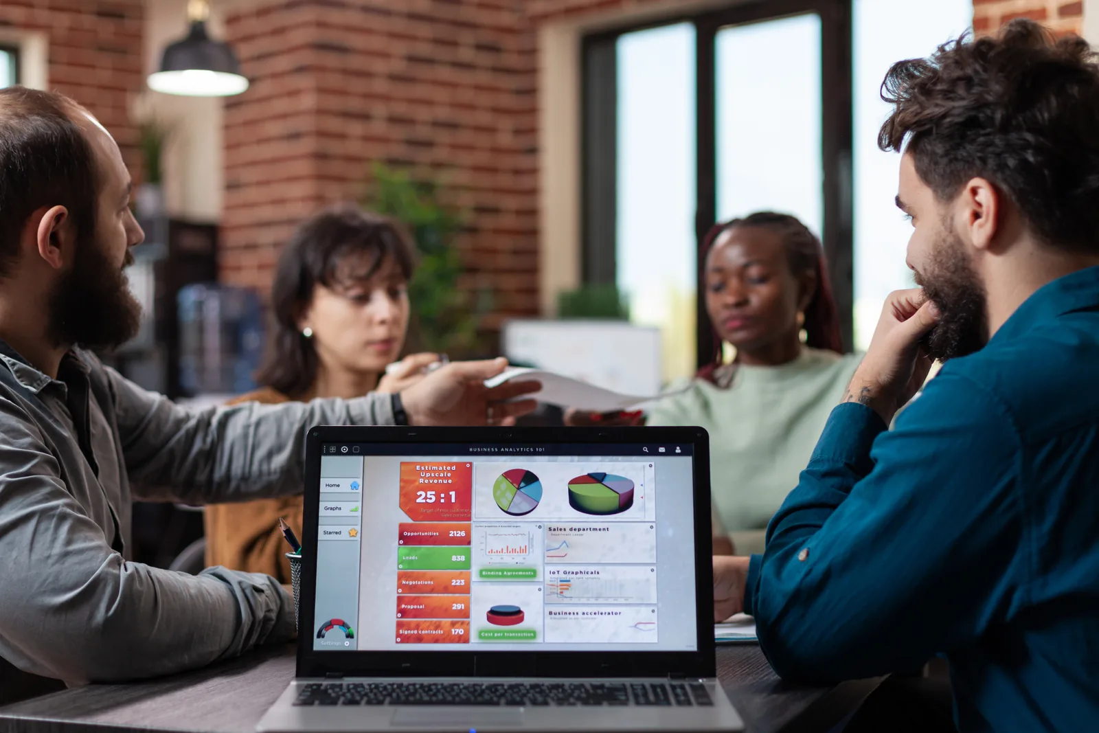 Marketing team analyzing automation dashboards on a laptop