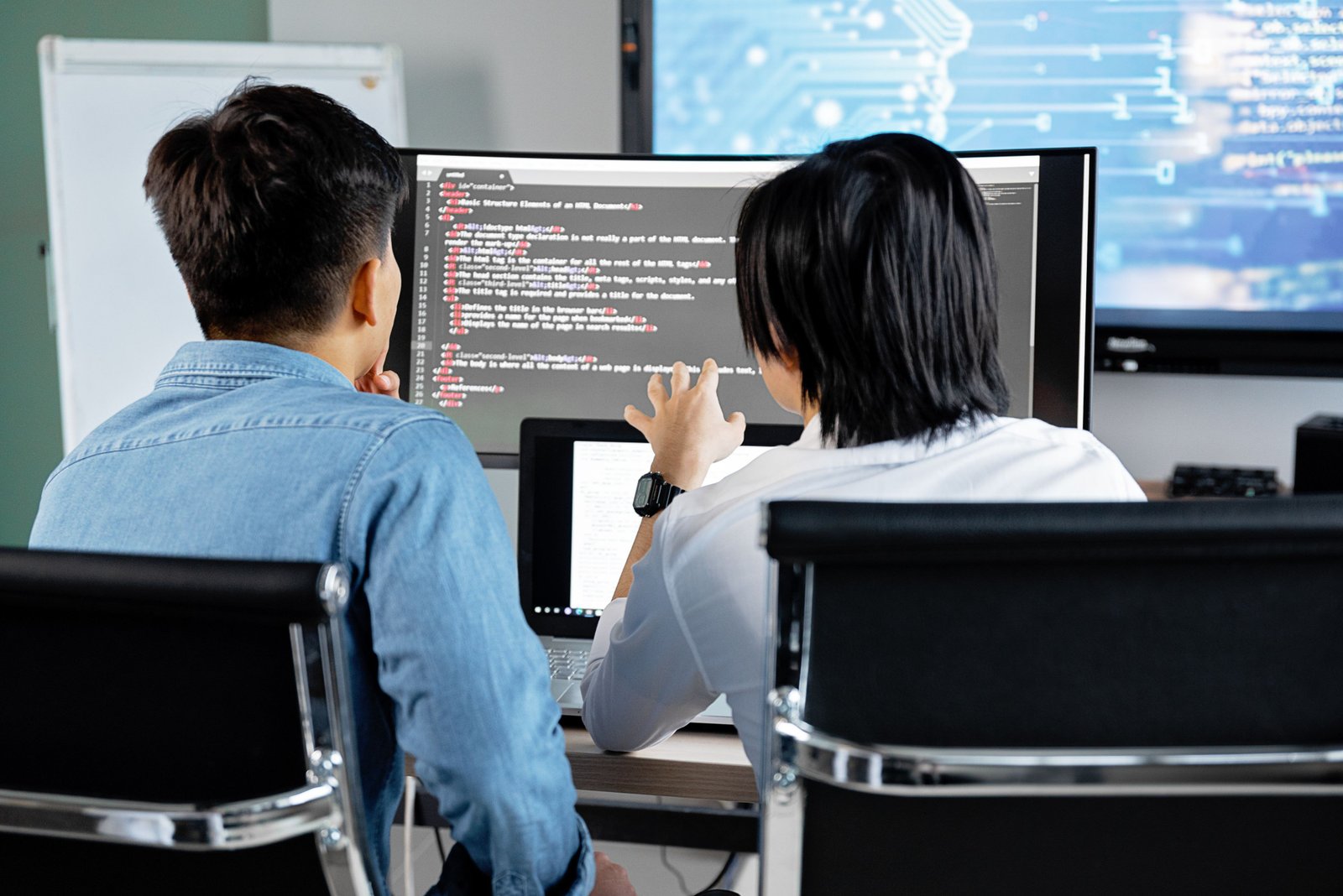 Engineers reviewing automation code together