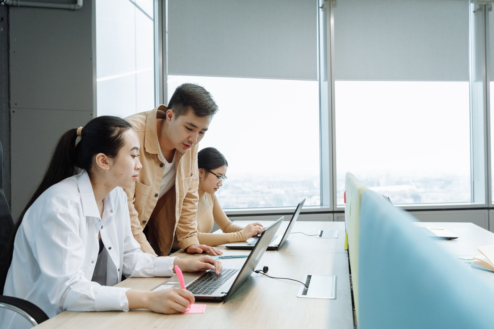 Designers and developers collaborating on laptops