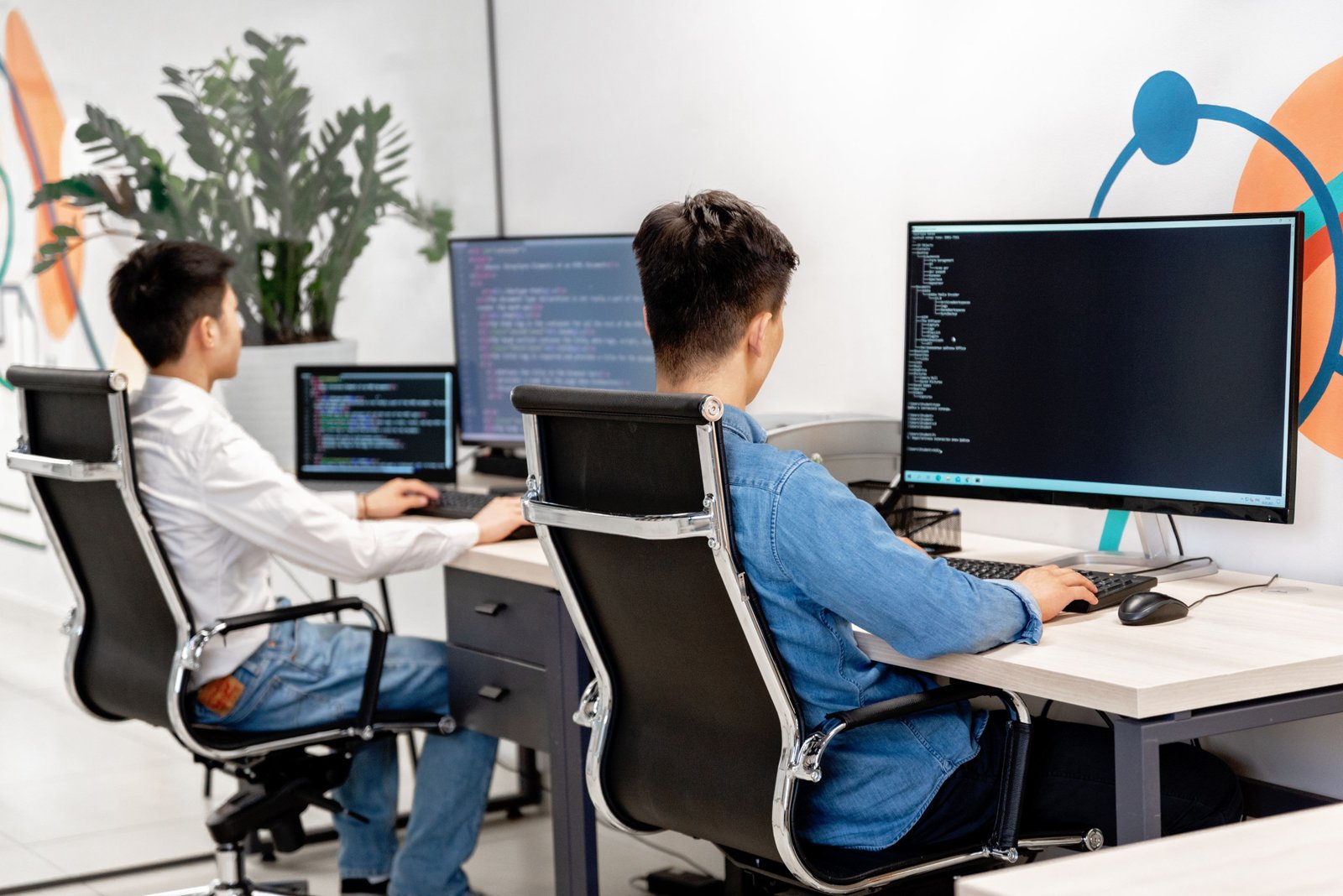 Developers at desks with large monitors