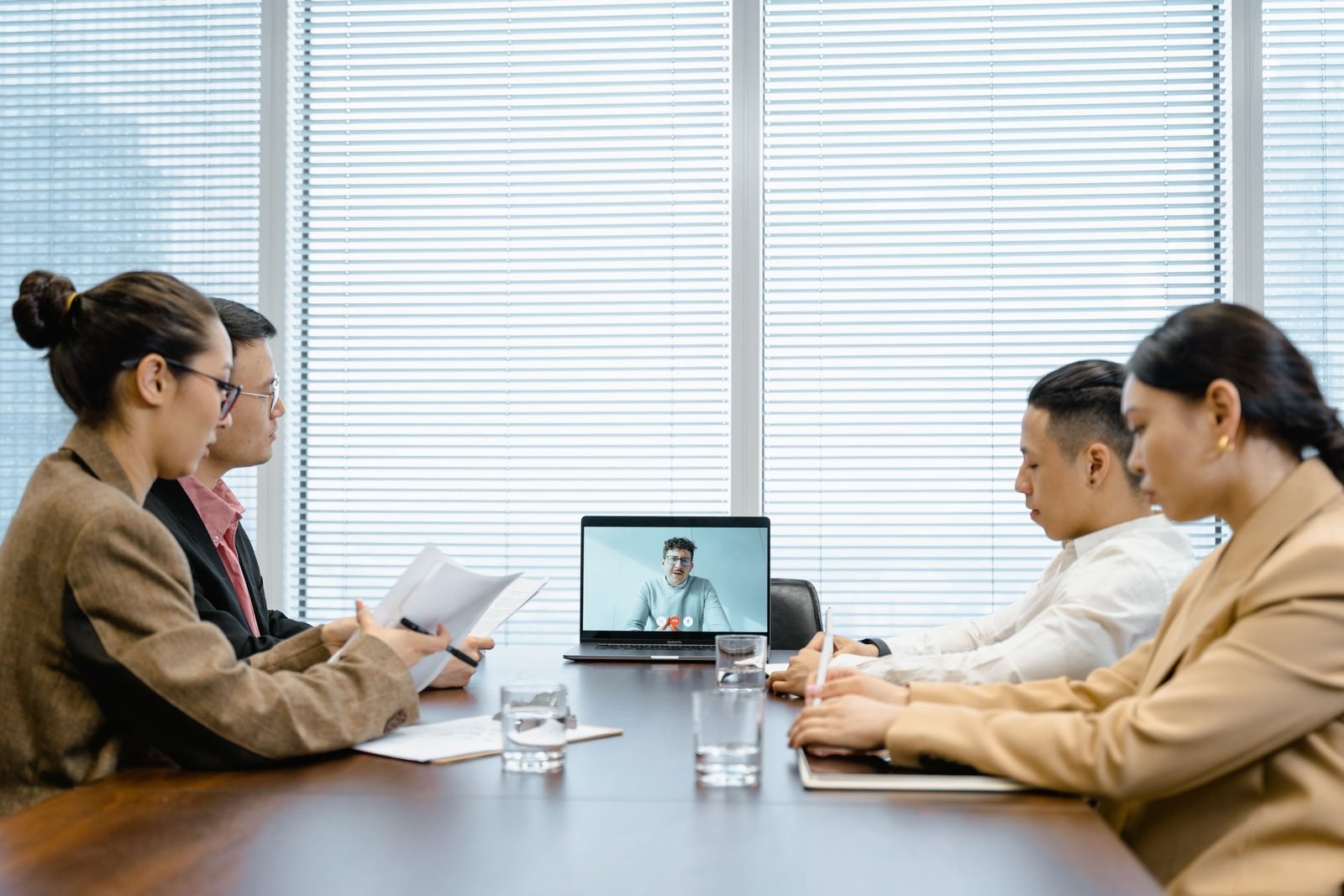 A Seiko Digital team in a standup with a remote teammate joining by video call